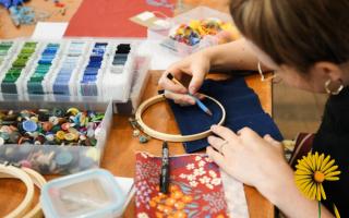 People attending the festival can embroider memory hoops at a workshop