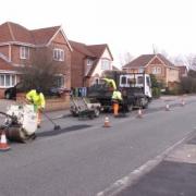 Council workmen repair potholes on Cherry Lane, Sale