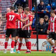 Regan Linney (second left) is congratulated after scoring in Saturday’s 4-2 defeat against Stockport County Picture Jonathan Moore