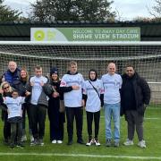 Trafford FC have entered a partnership with an Urmston-based community care provider that means their ground will now be known as the Away Day Care Shawe View Stadium. Pictured are the proprietors, staff and service users of the company at the stadium