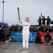 Sir Bobby with the torch outside Old Trafford stadium