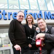 Trafford Shopmobility manager Phil Simmons with Stretford Mall centre administrator Maria Garrity, and Traffod Shopmobility service user Kevin Lomas