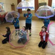 Rainbows and Beavers practising for Singing in the Rain