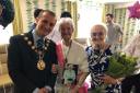 CELEBRATING: Miss Higginson, centre, with a friend and the Mayor of Trafford, Tom Ross
