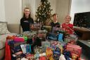 PLEASED: Eleanor, Isaac & Noah with the gifts they bought for children from low-income families.