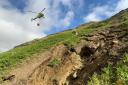 Photo issued by BEAR Scotland of a helicopter that was being used to clear a 100-tonne boulder from above the A83 Rest and Be Thankful in August, 2020 as efforts to clear a large landslip continued,