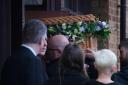 Sir Tony's coffin is taken into St Hugh of Lincoln RC Church