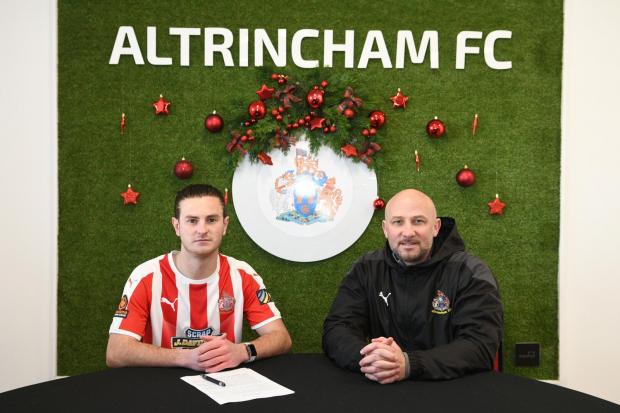 NEW FACE: Jamie Morgan signs for Alty at The J.Davidson Stadium alongside manager Phil Parkinson. Picture by Michael Ripley