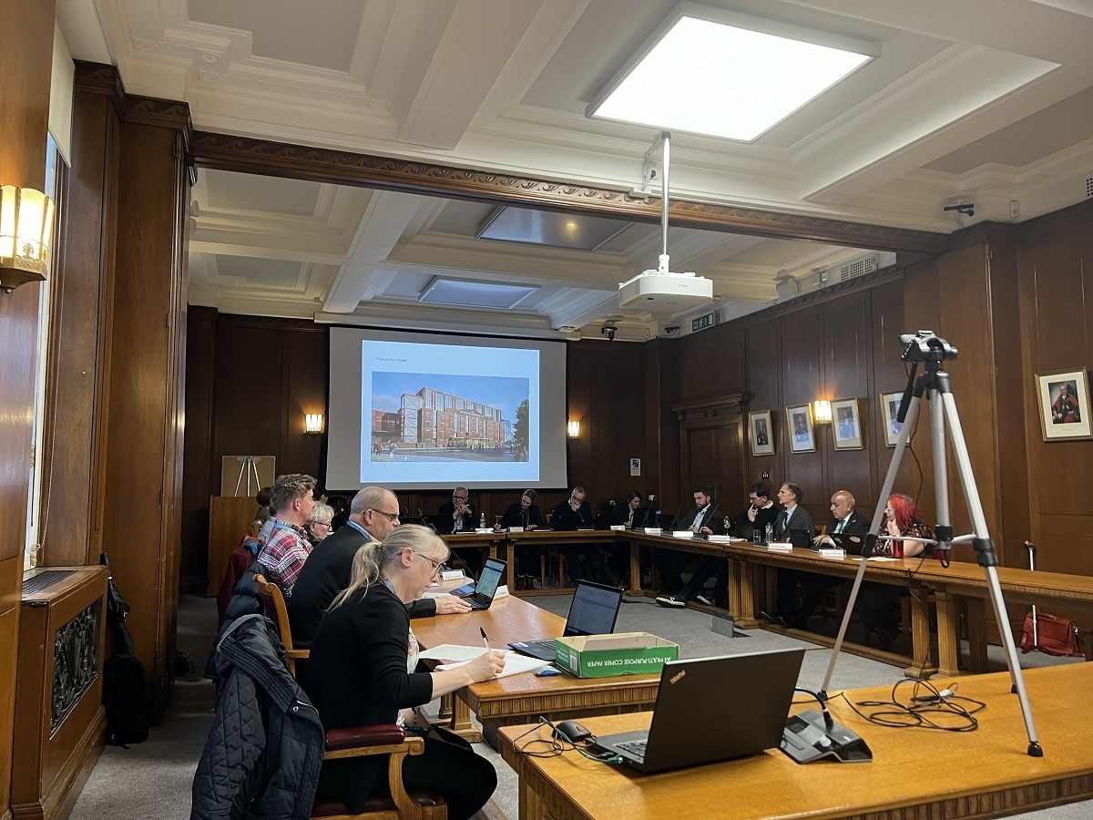 Councillors on Traffords planning committee discuss the Victoria Warehouse scheme with an image depicting the iconic building on the big screen