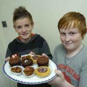 Sam Dickinson and Chris Binns who along with friends, raised over £130 selling cakes.