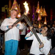 Simon Weston (left) and Nazim Erdem with the Welsh National Flame during the parade to the evening celebration site, Cardiff.