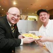 From left to right; Stretford Mall Manager Gareth Wilkins and Jack Cartwright of Kingfisher Chippy