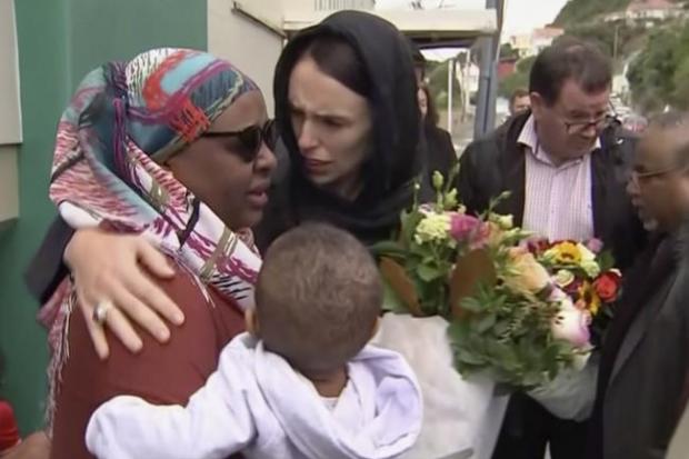 New Zealand’s Prime Minister Jacinda Ardern hugs and consoles a woman as she visited Kilbirnie Mosque to lay flowers